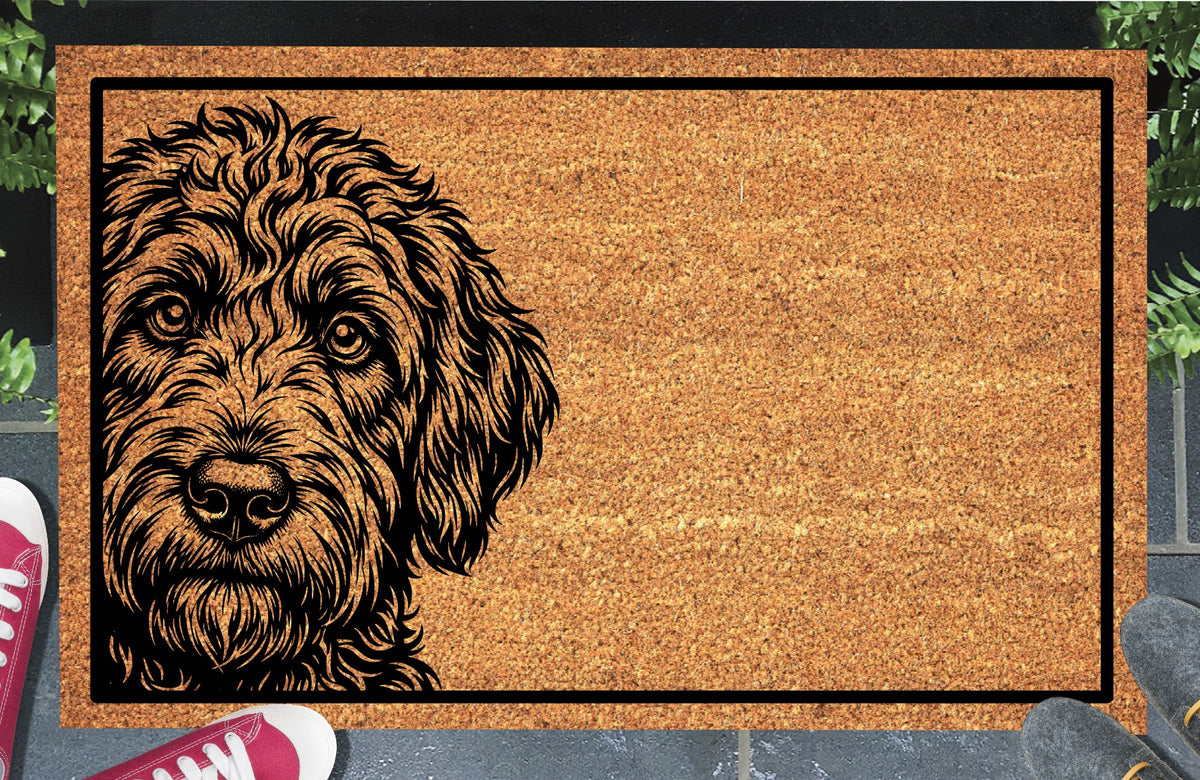 Labradoodle Peeking Doormat #1, shaggy Doodle portrait on the left with a black border, natural coir mat styled at an entryway.