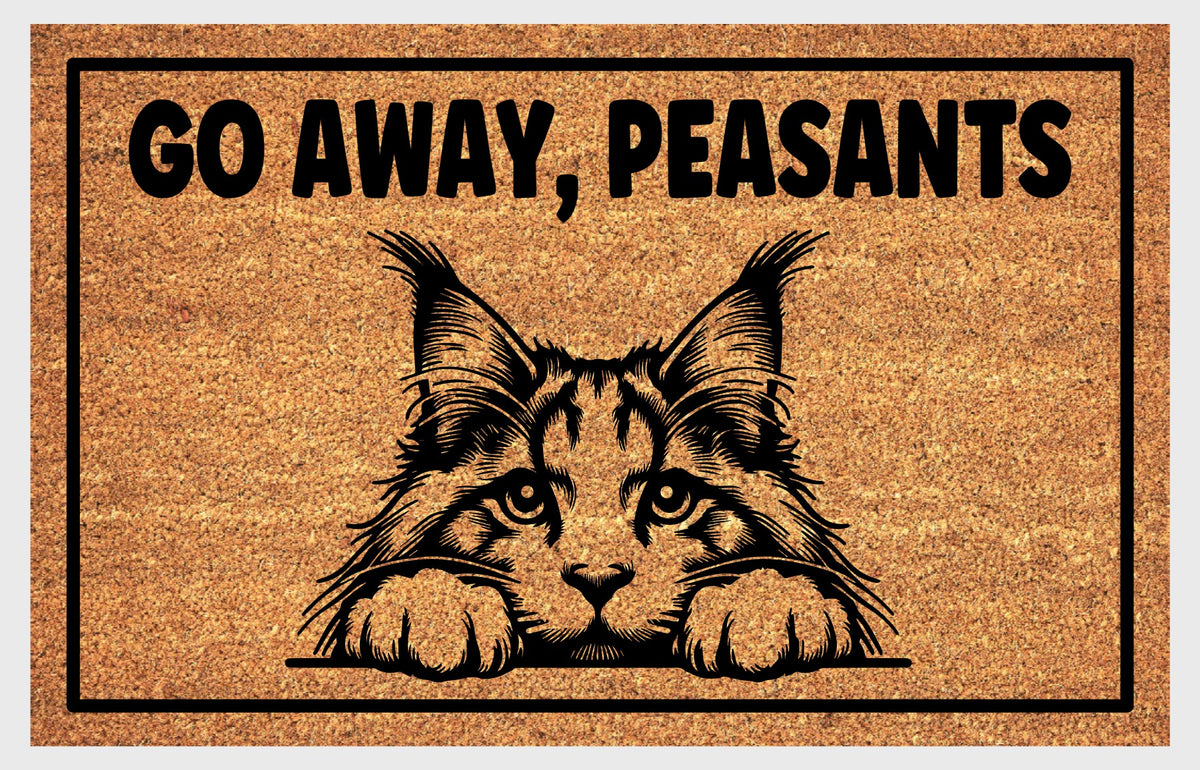 Maine Coon cat Go Away Peasants coir doormat flat lay — large fluffy cat peering beneath bold Go Away Peasants text