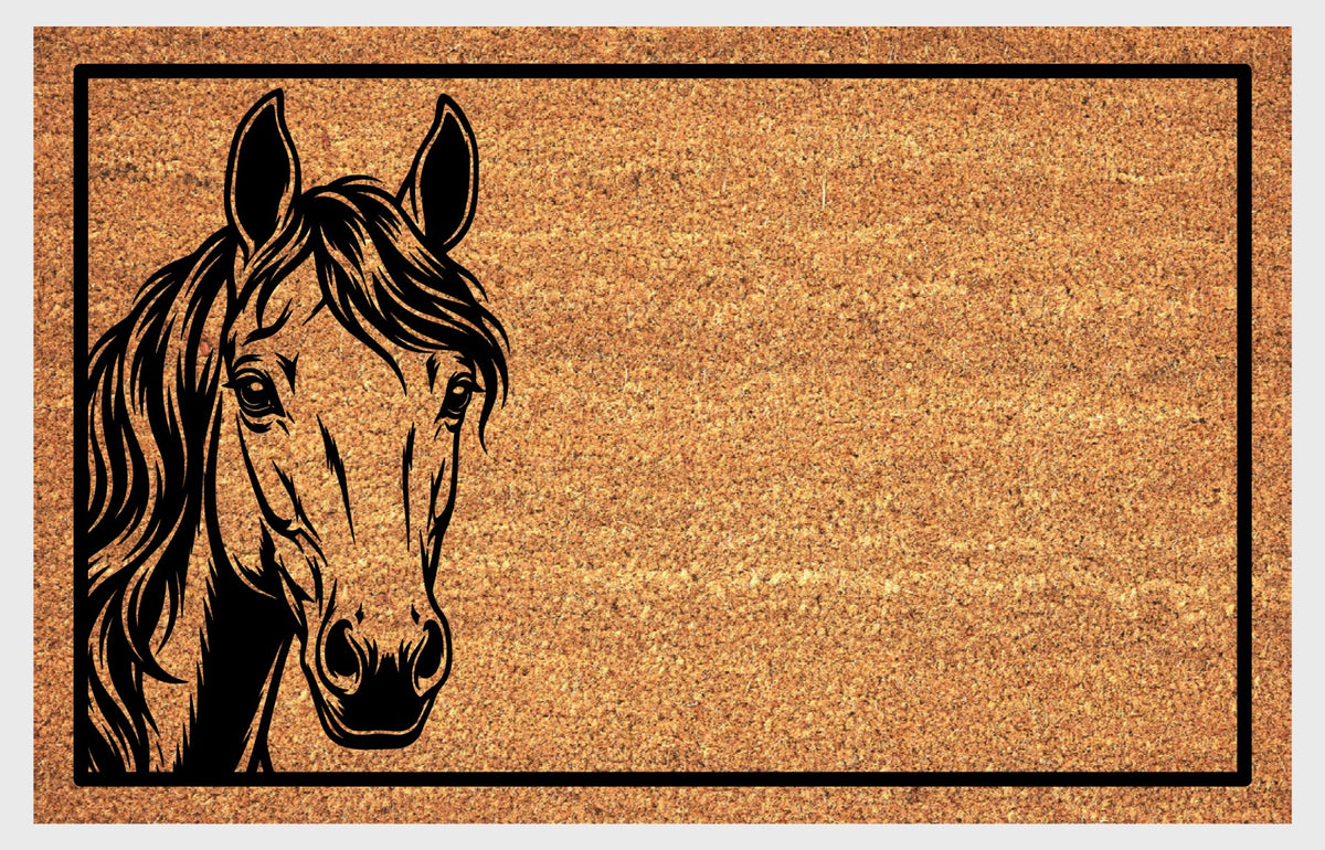Close-up of a Morgan Horse peeking natural coir doormat, showing its expressive face, upright ears, long wavy mane and black rectangular border.