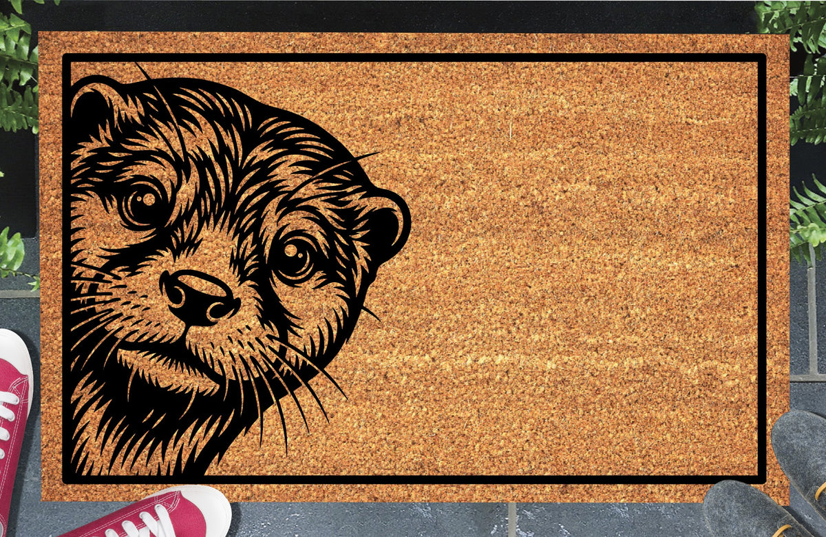 Otter Peeking Doormat #1, whiskered Otter portrait peeking from the left inside a black border, natural coir mat styled at an entryway.