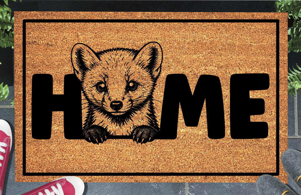 Pine Marten coir doormat lifestyle shot — Pine Marten illustration replaces the letter O in HOME, natural coir mat on a doorstep
