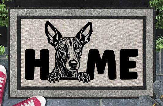 Podenco all-weather doormat #8 with Mediterranean Hound illustration replacing the letter O in HOME — woven polyester welcome mat by Pupular Mats