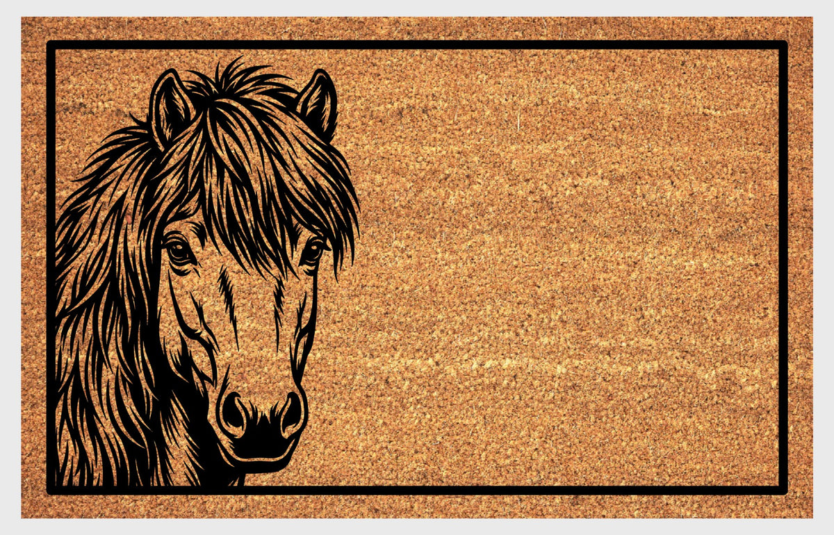 Shetland Pony peeking doormat in natural coir, featuring a black pony portrait peeking from the left edge with small upright ears, expressive eyes, a heavy forelock and a shaggy mane inside a black rectangular border, shown flat.