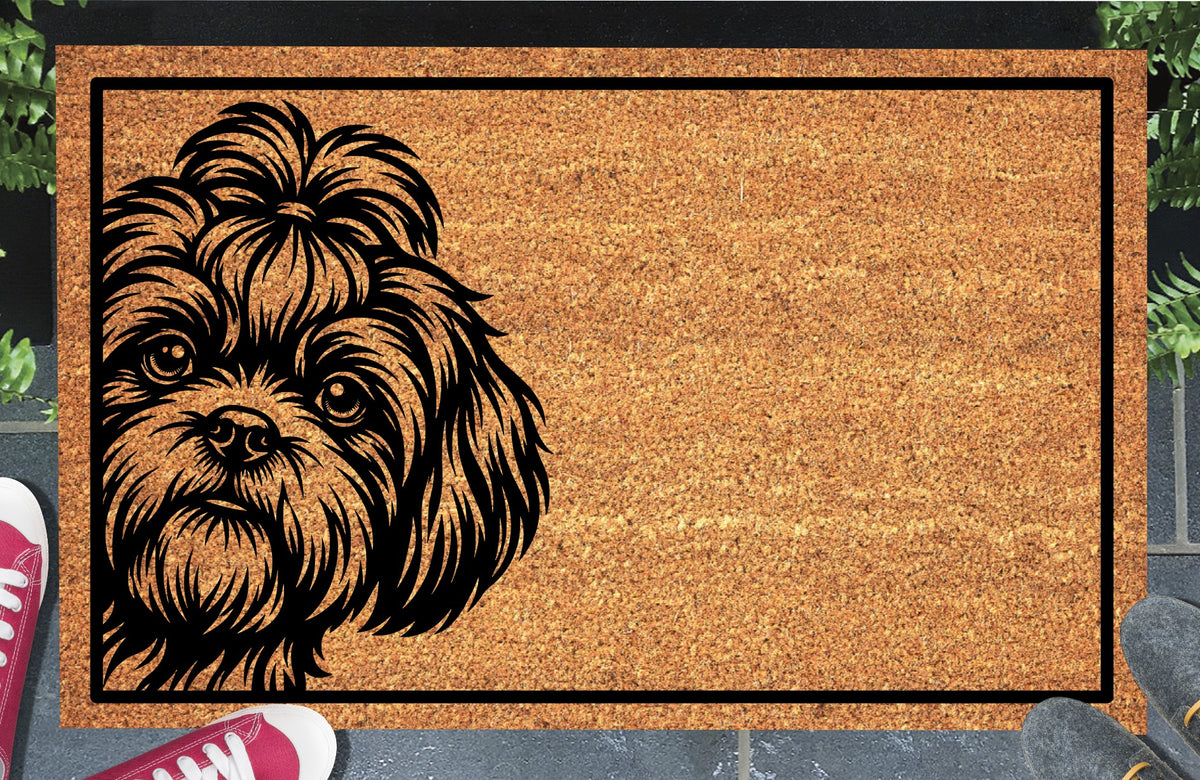 Shih Tzu Peeking Doormat #1, Shih Tzu with a topknot peeking from the left inside a black border, natural coir mat styled at an entryway.