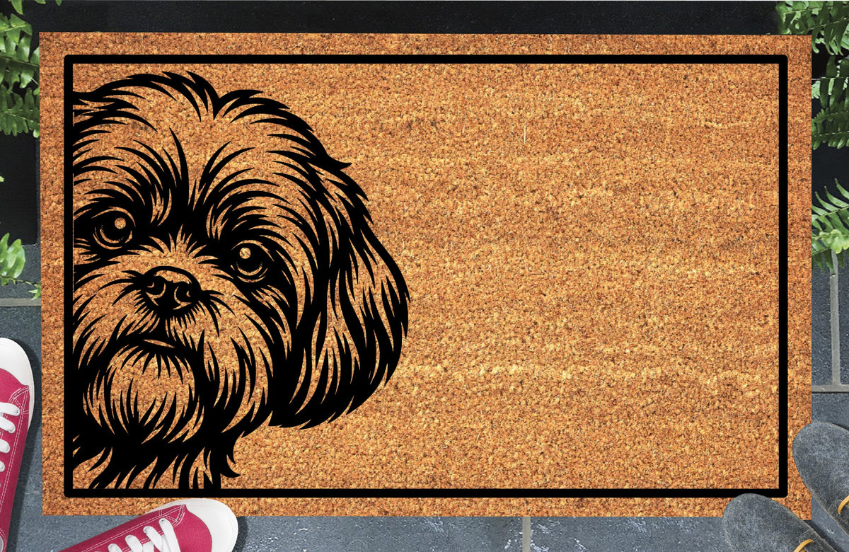 Shih Tzu Peeking Doormat #2, shaggy Shih Tzu peeking from the left inside a black border, natural coir mat styled at an entryway.