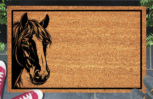 Shire Horse peeking from the left edge of a natural coir doormat, with a flowing mane and black rectangular border, shown at a doorstep.