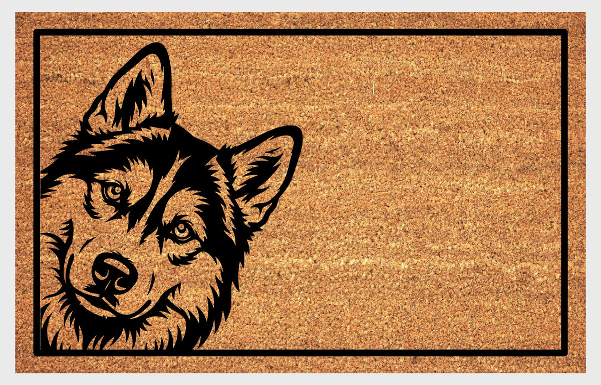 Siberian Husky peeking design on natural coir, showing a tilted head, upright ears and expressive eyes within a black rectangular border.