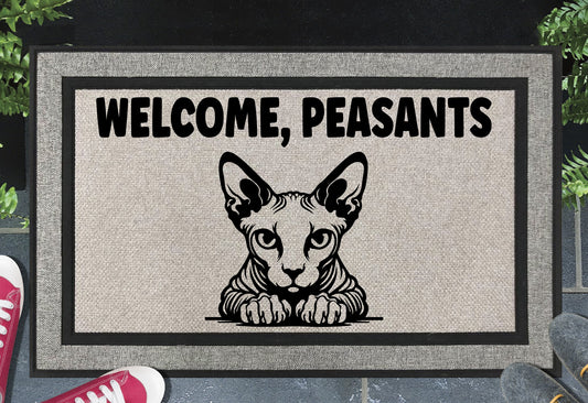 Sphynx cat Welcome Peasants all-weather doormat flat lay — hairless cat peering beneath bold Welcome Peasants text