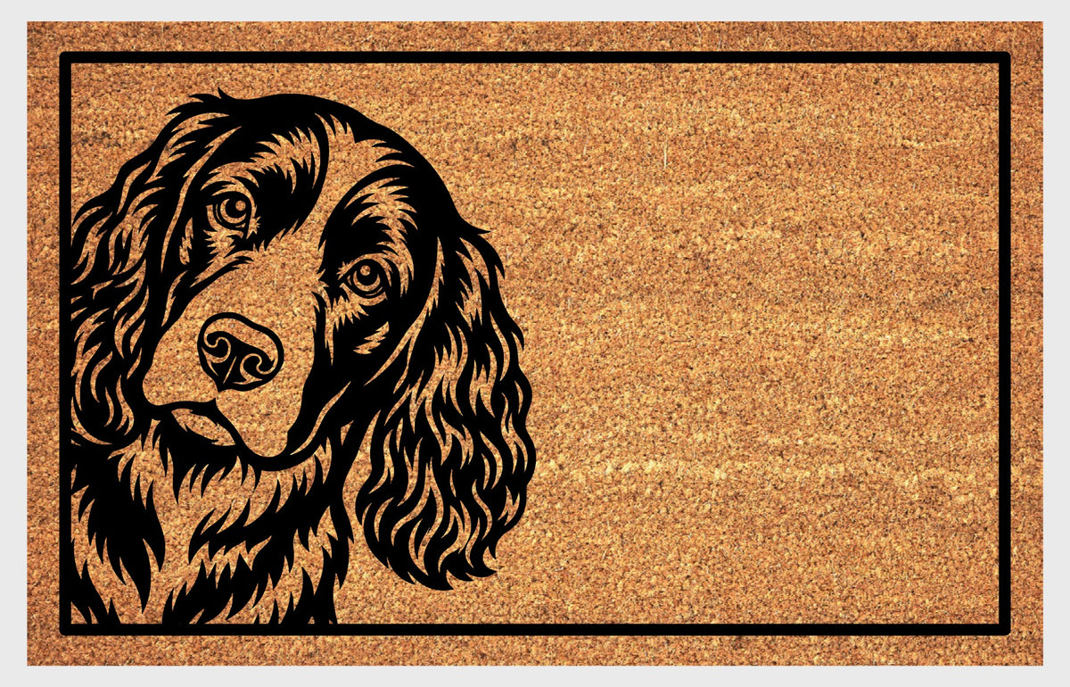Springer Spaniel peeking design on natural coir, showing a tilted head, expressive eyes and long feathered ears within a black rectangular border.