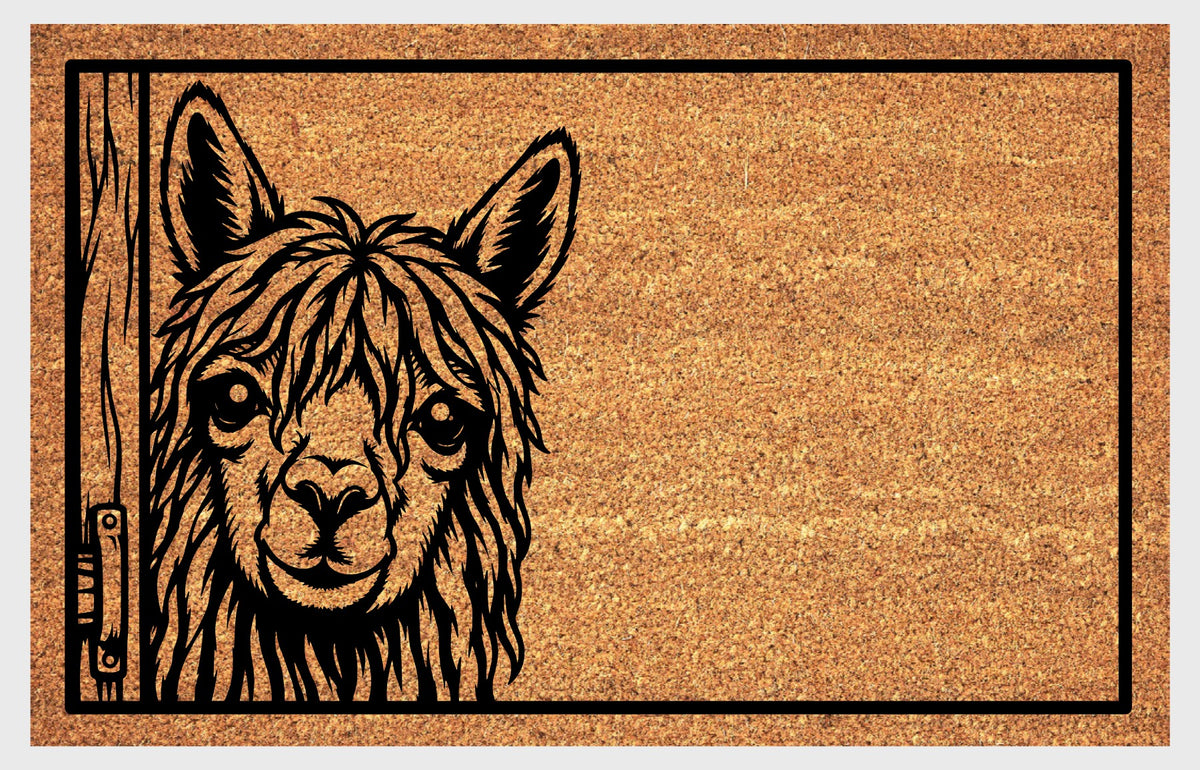 Suri Alpaca doormat showing long locks, expressive eyes and upright ears beside a wooden door edge within a black border.