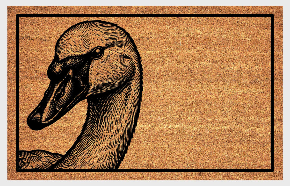 Natural coir doormat featuring a Trumpeter Swan peeking from the left edge, with a curved neck, finely lined feathers, black bill and black rectangular border.
