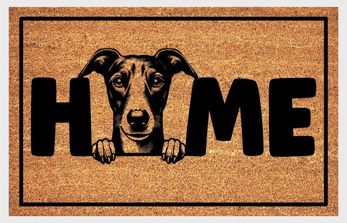 Whippet Doormat #3, showing a forward-facing English Whippet with folded ears, dark facial shading and two front paws replacing the O in HOME.