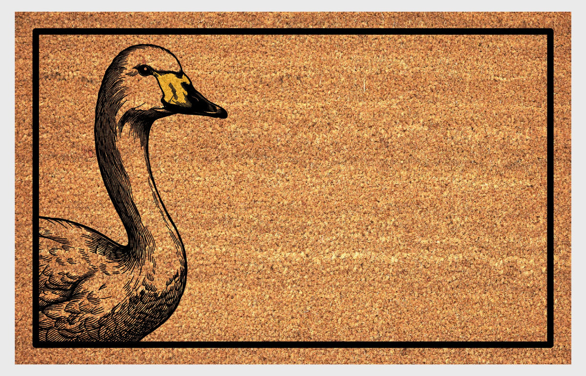 Natural coir doormat featuring a Whooper Swan peeking from the left edge, with a long curved neck, detailed feathered body, yellow-and-black bill and black rectangular border.