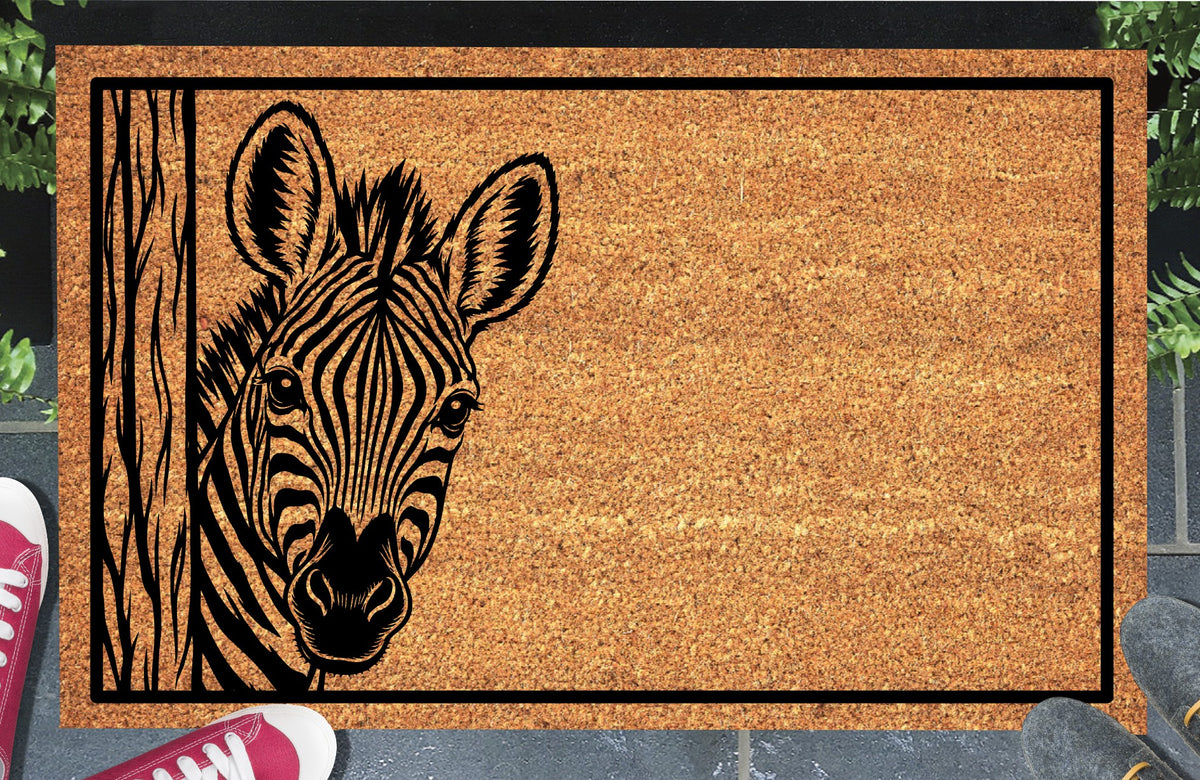 Zebra Peeking Doormat #2, Zebra peeking around a wood-grain post on the left inside a black border, natural coir mat styled at an entryway.